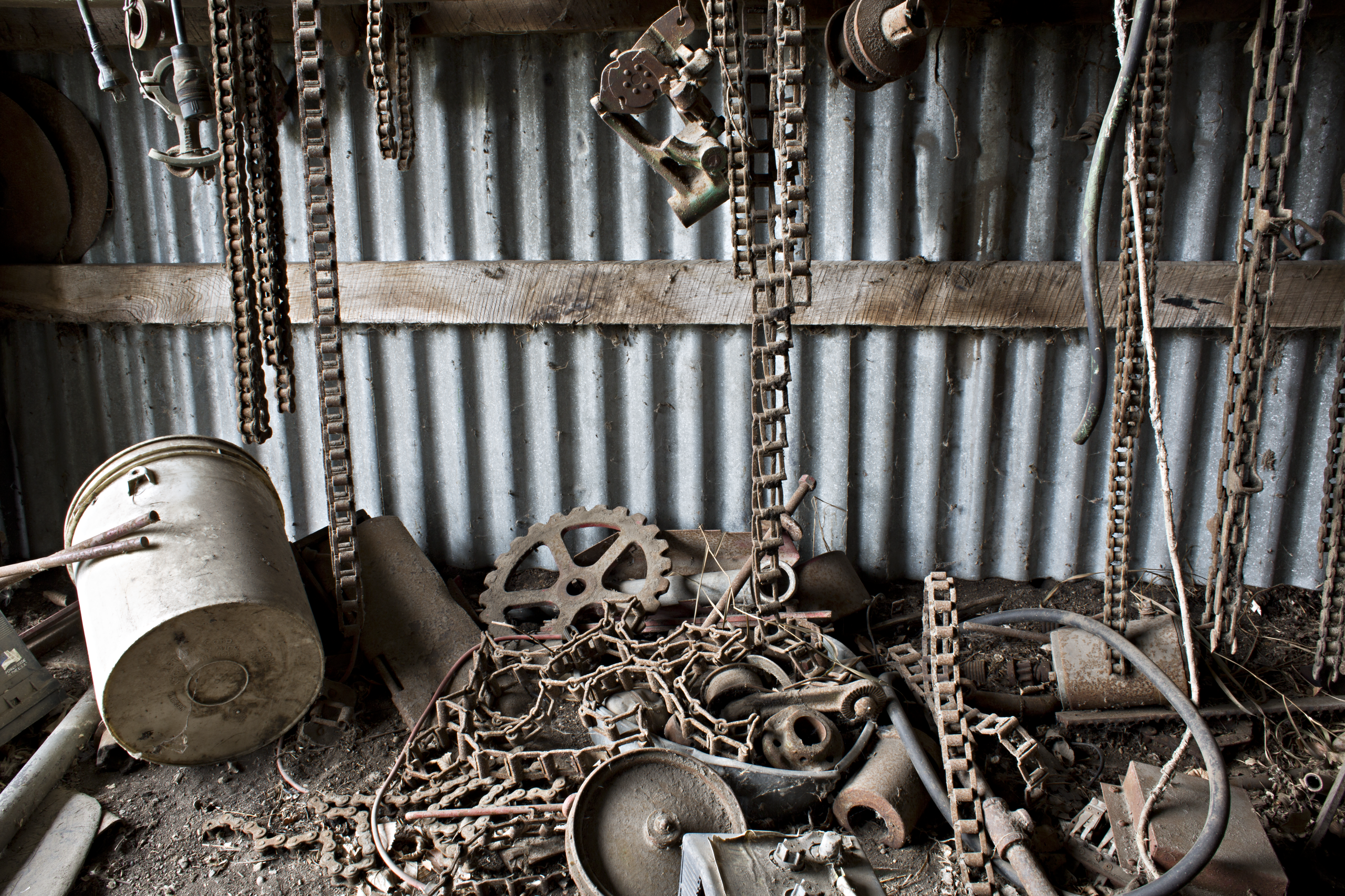 Abandoned Farm Study: Vertical Chains, Gears and an overturned bucket. Photography 2015